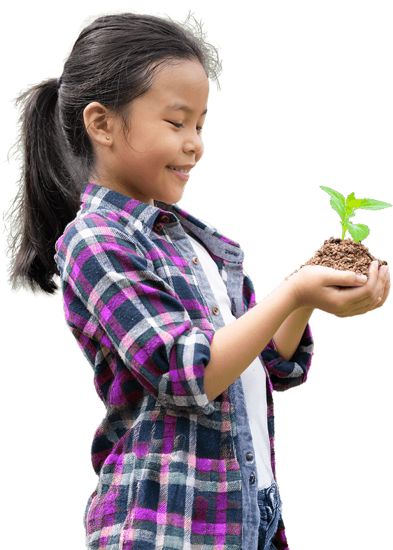 A young girl holds a small potted plant in her hands